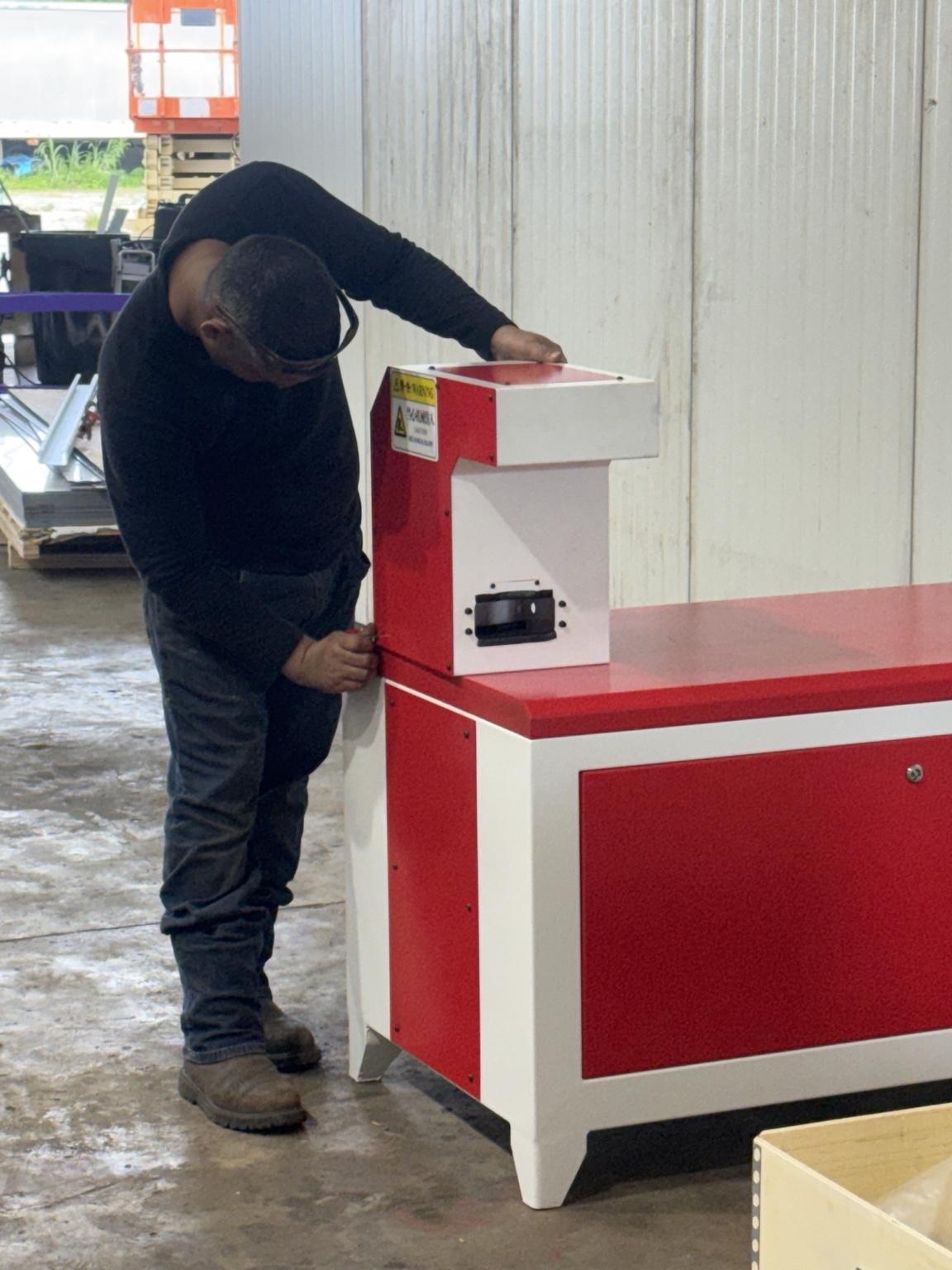 Team member assembling the fiber laser equipment