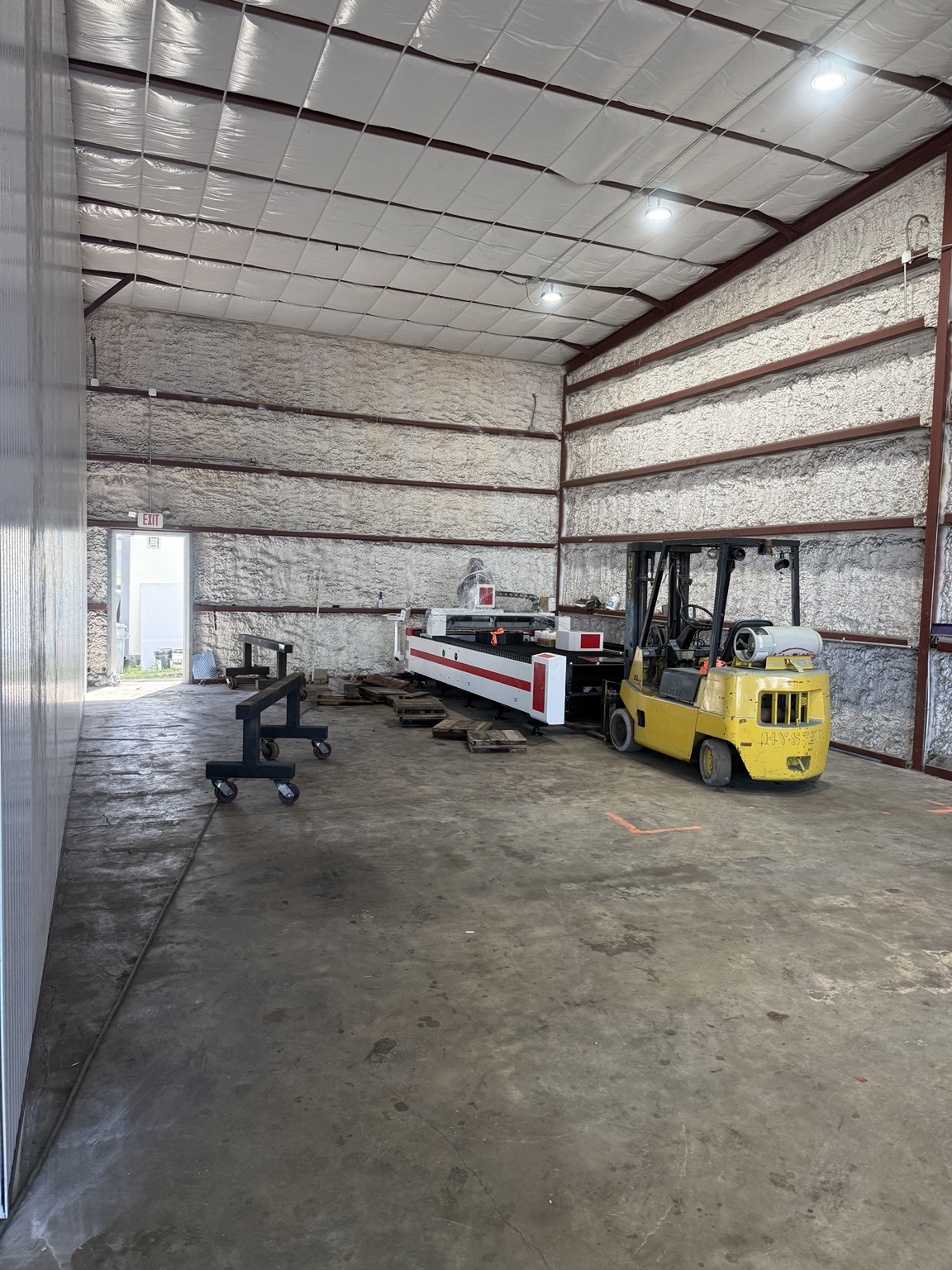 New laser table positioned in its shop space during installation
